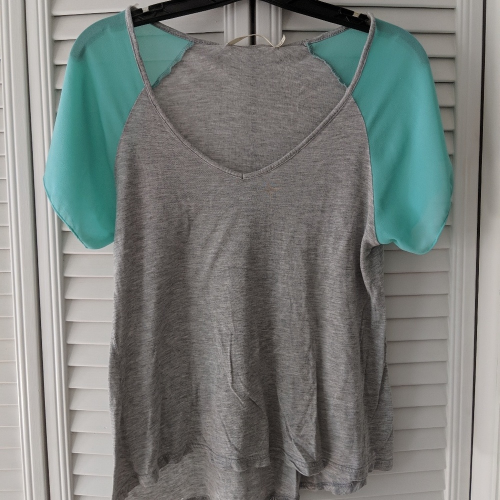 Mint green and grey shirt.